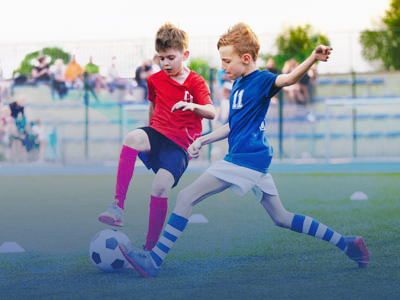2 boys playing soccer