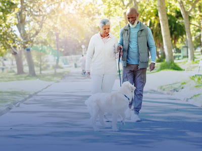 elder couple with dog outside